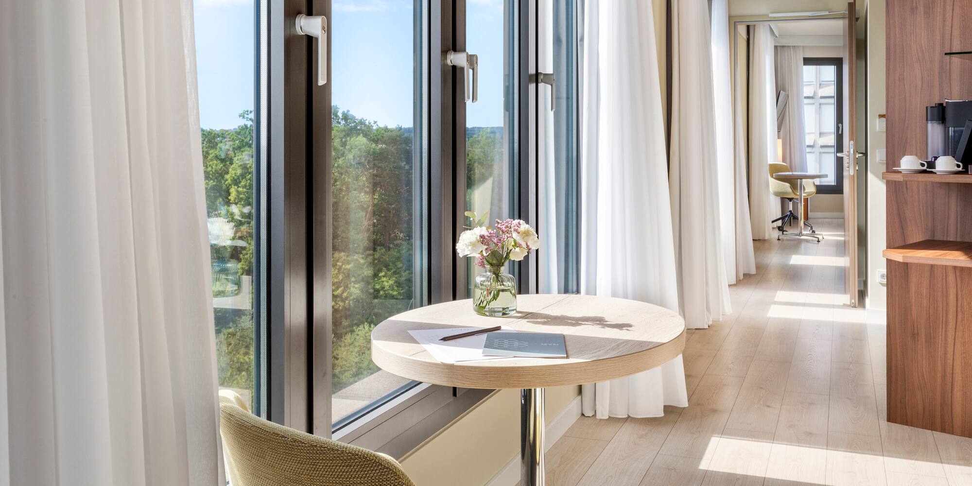 a table with flowers on it by a window