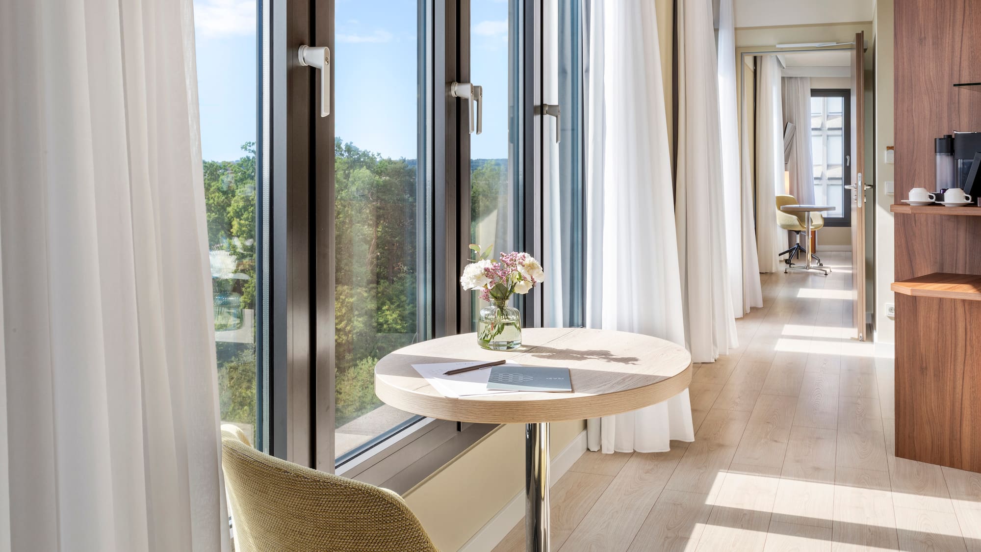 a table with flowers on it by a window