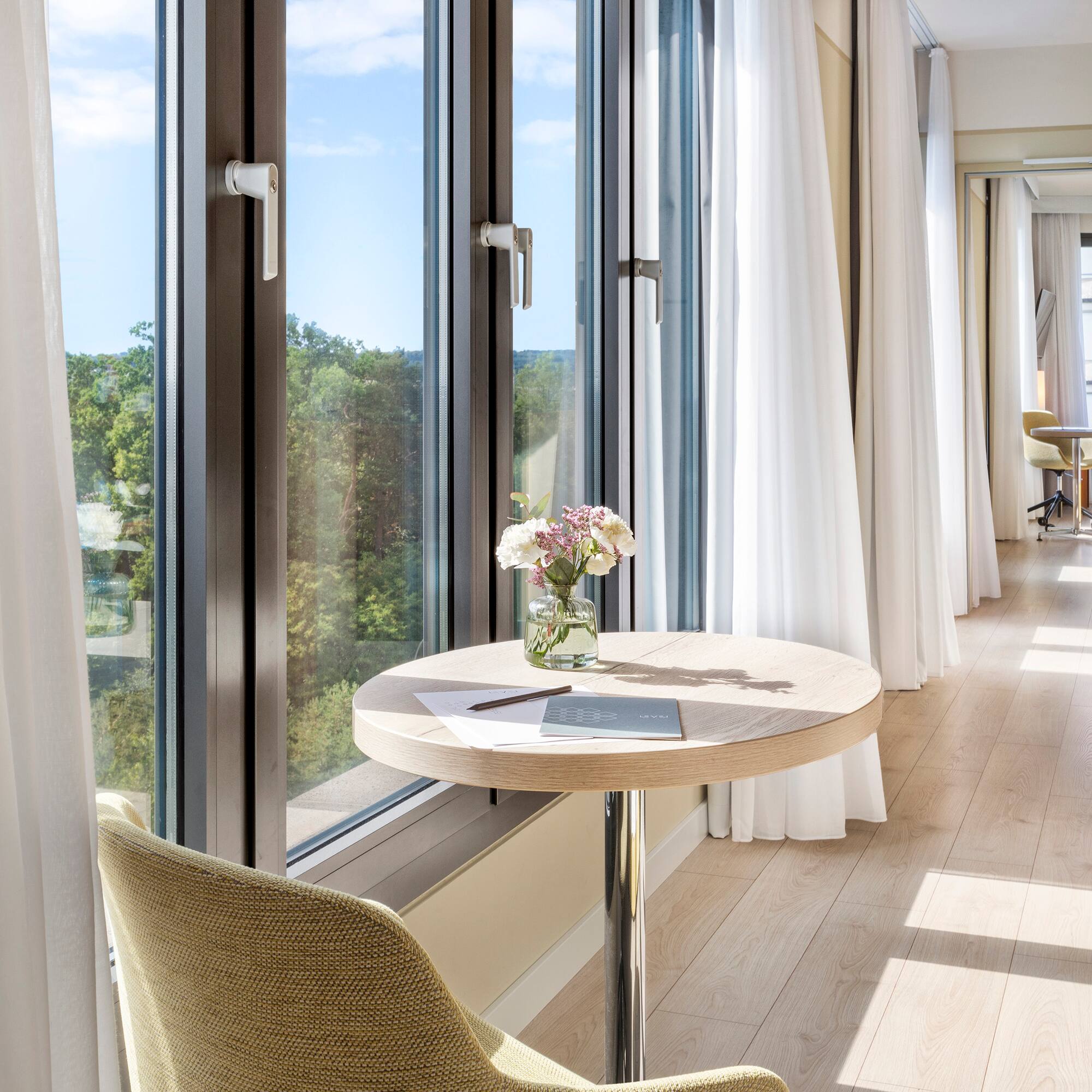 a table with flowers on it by a window