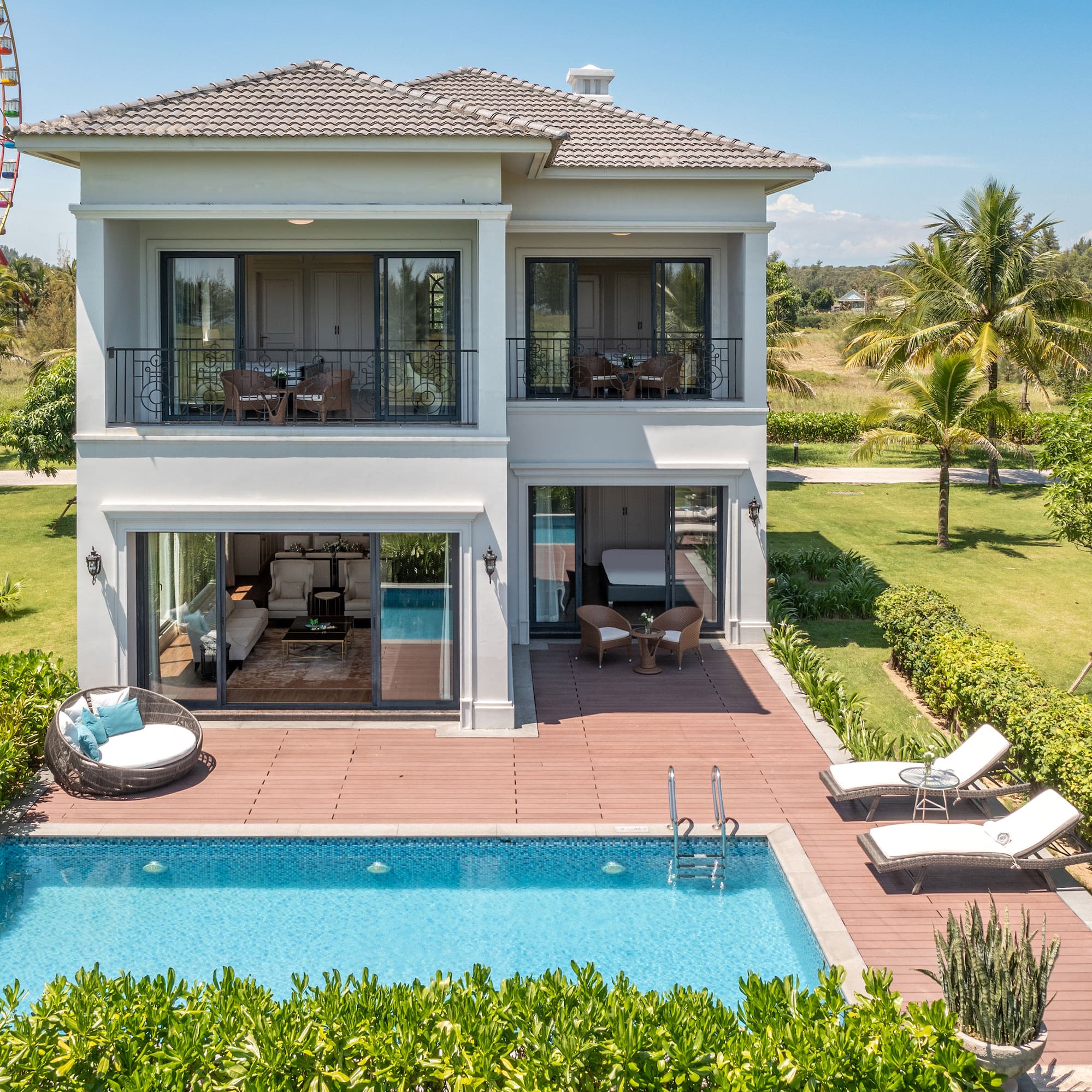 a house with a pool and a ferris wheel