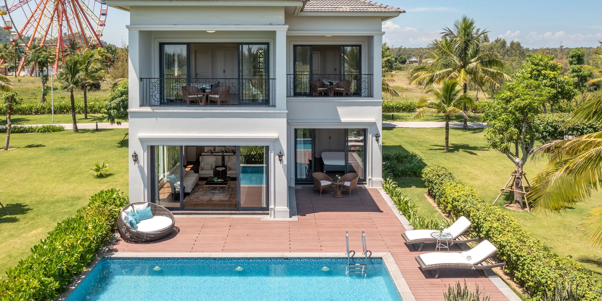 a house with a pool and a ferris wheel