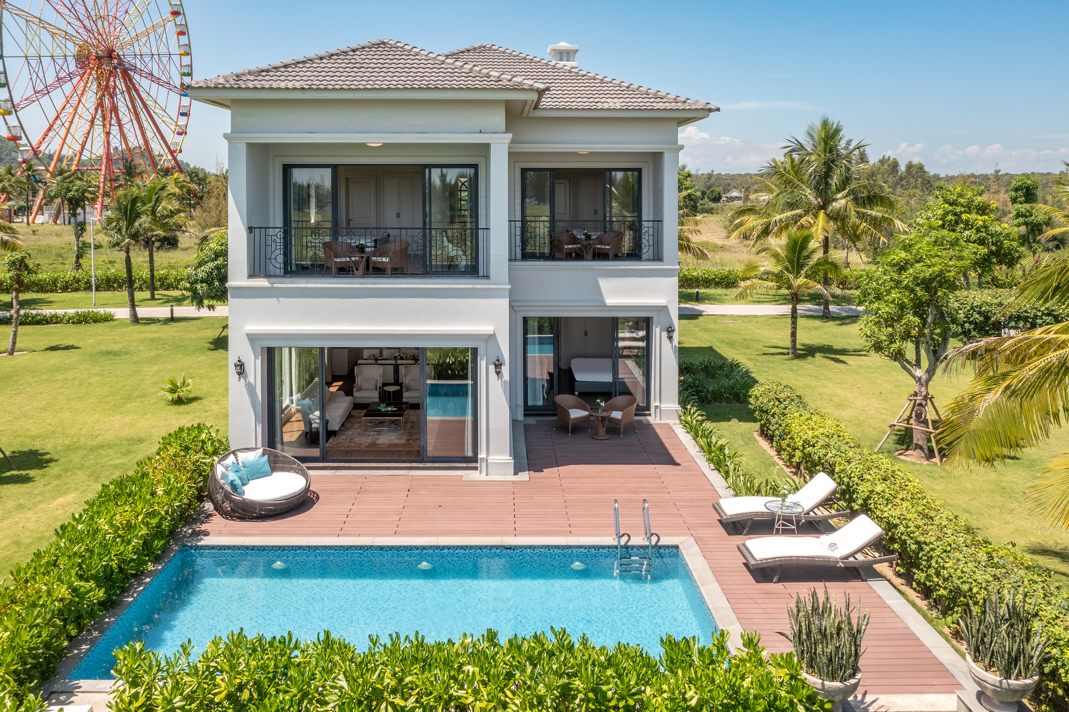 a house with a pool and a ferris wheel