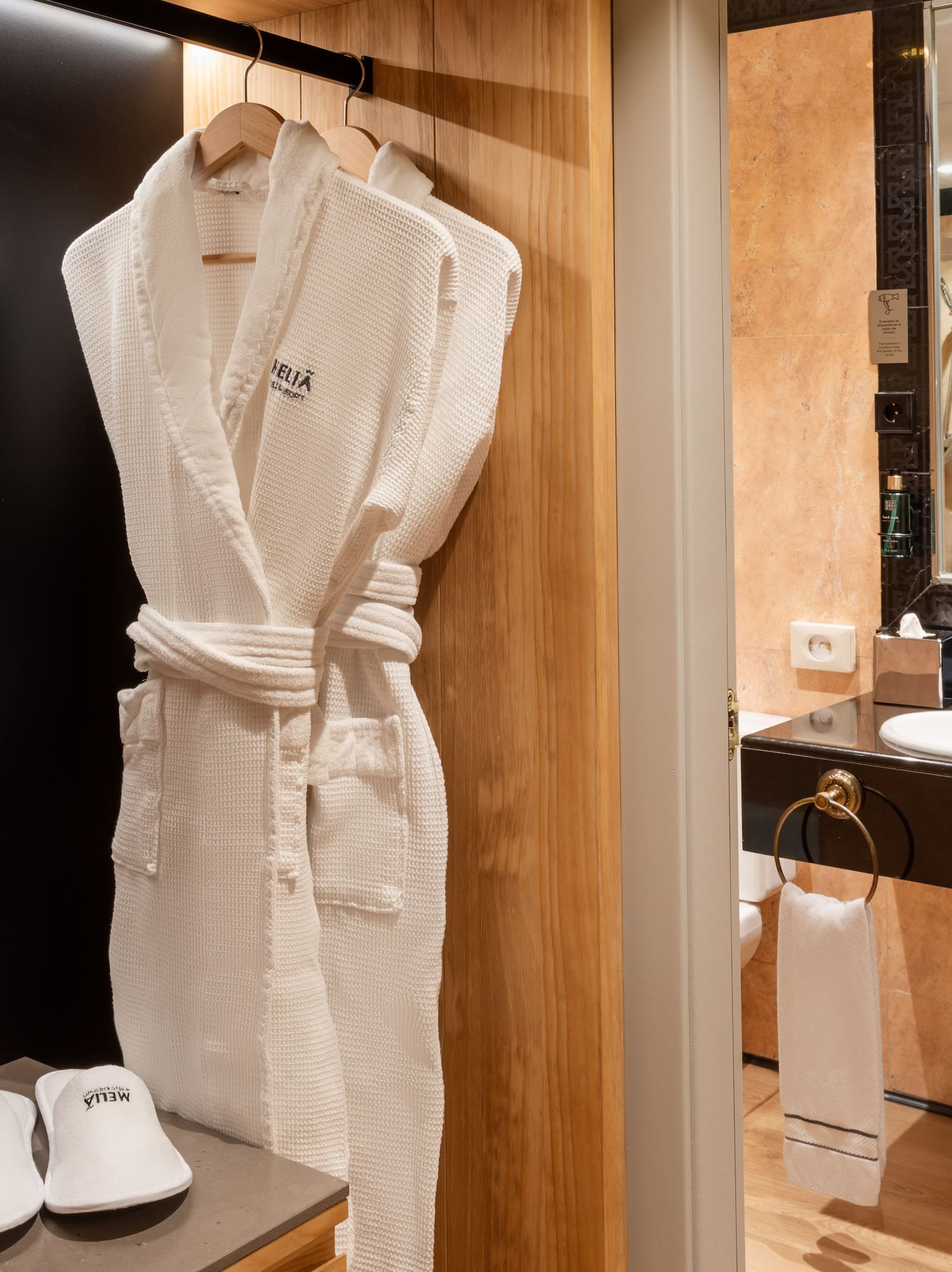 a white robe on a rack in a bathroom