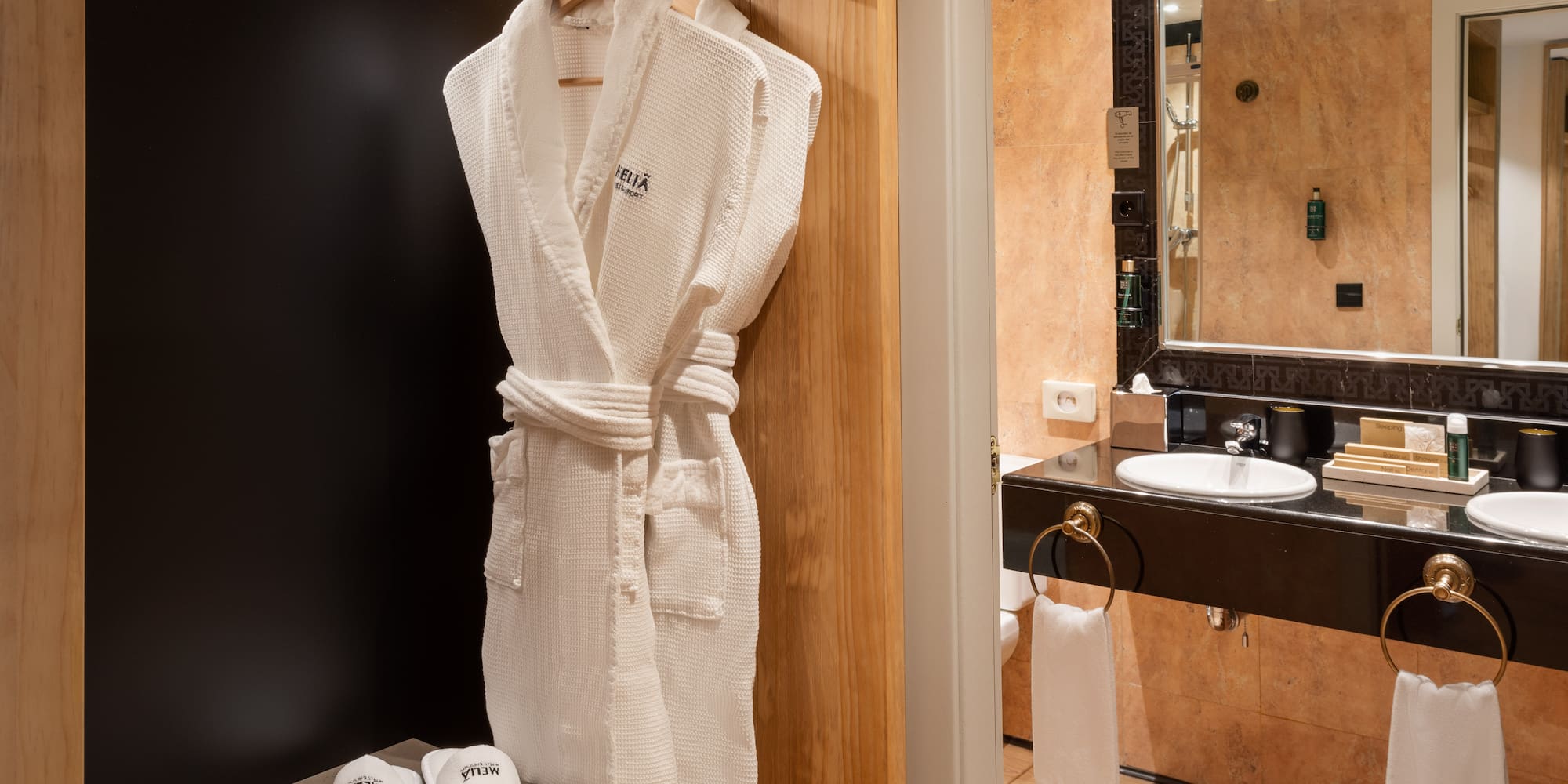 a white robe on a rack in a bathroom