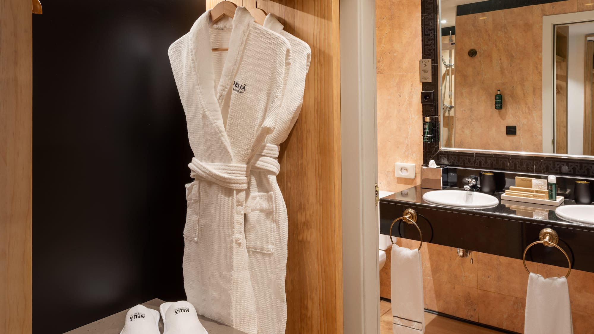 a white robe on a rack in a bathroom