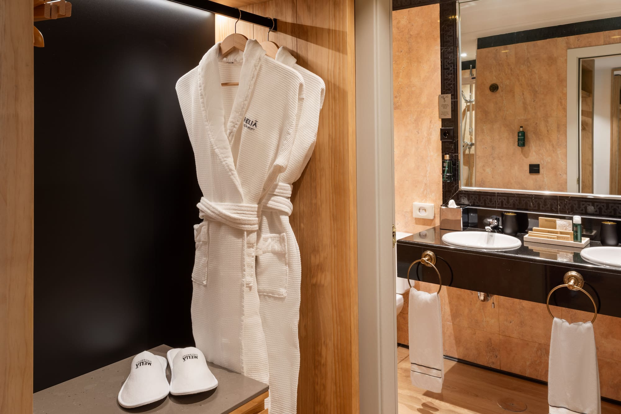 a white robe on a rack in a bathroom