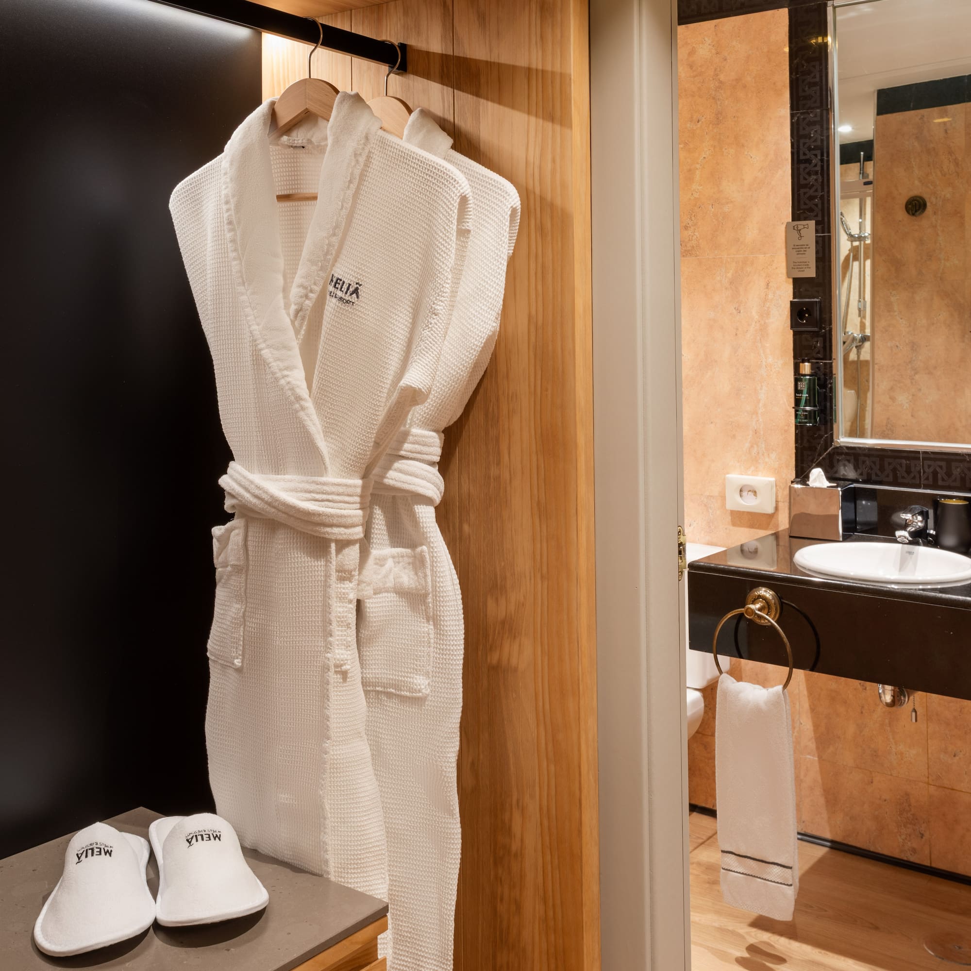 a white robe on a rack in a bathroom
