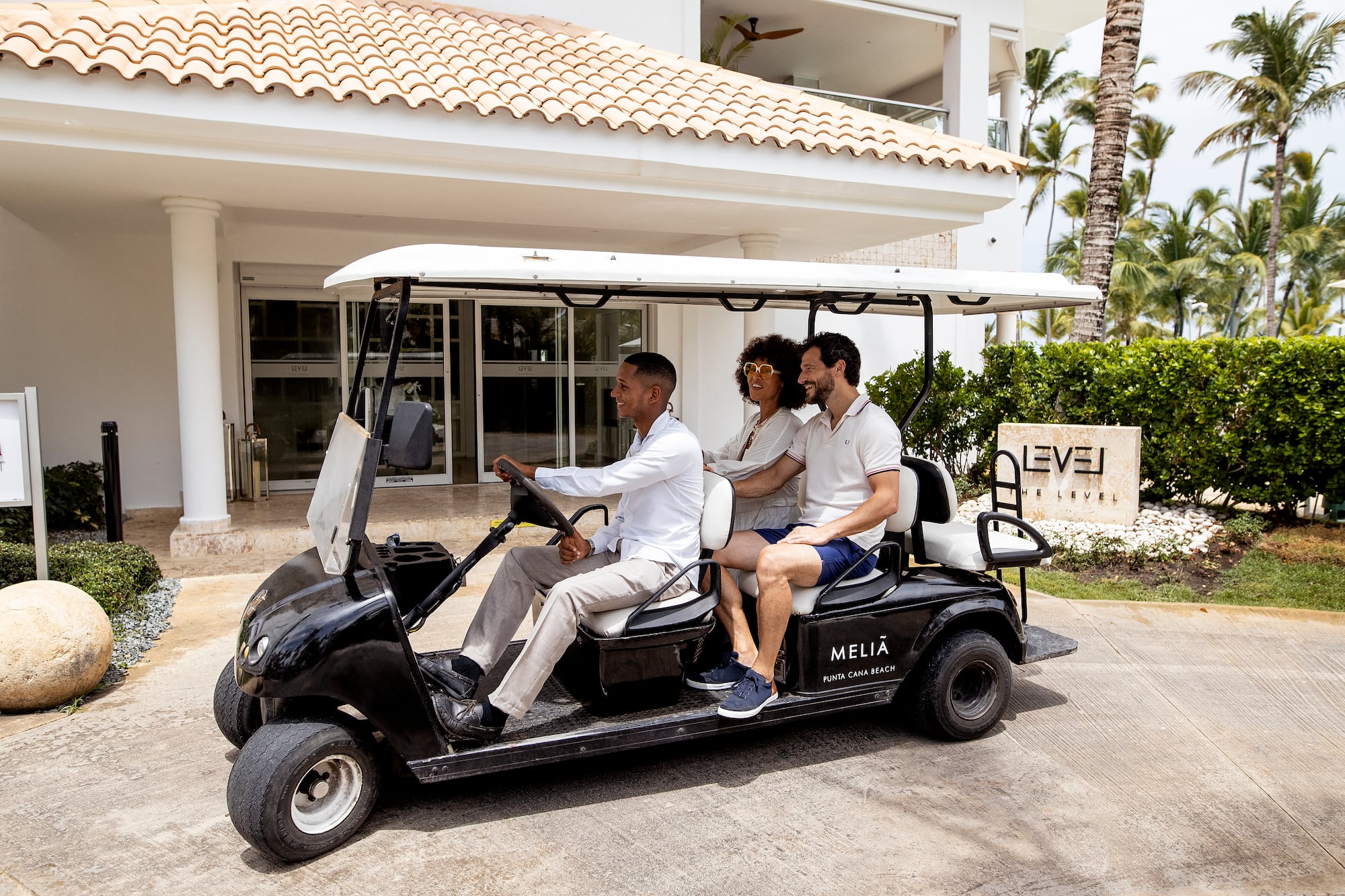 a group of people in a golf cart