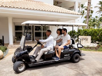 a group of people in a golf cart