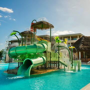 a water park with a slide and a pool