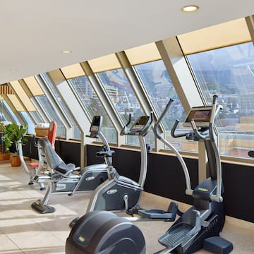 a room with exercise machines and windows