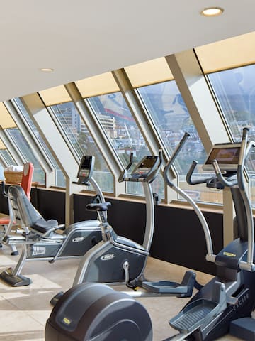 a room with exercise machines and windows