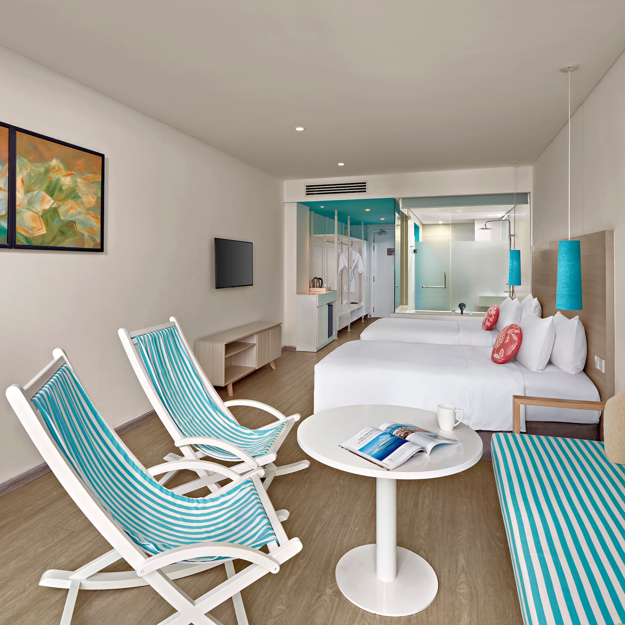 a room with a bed and chairs