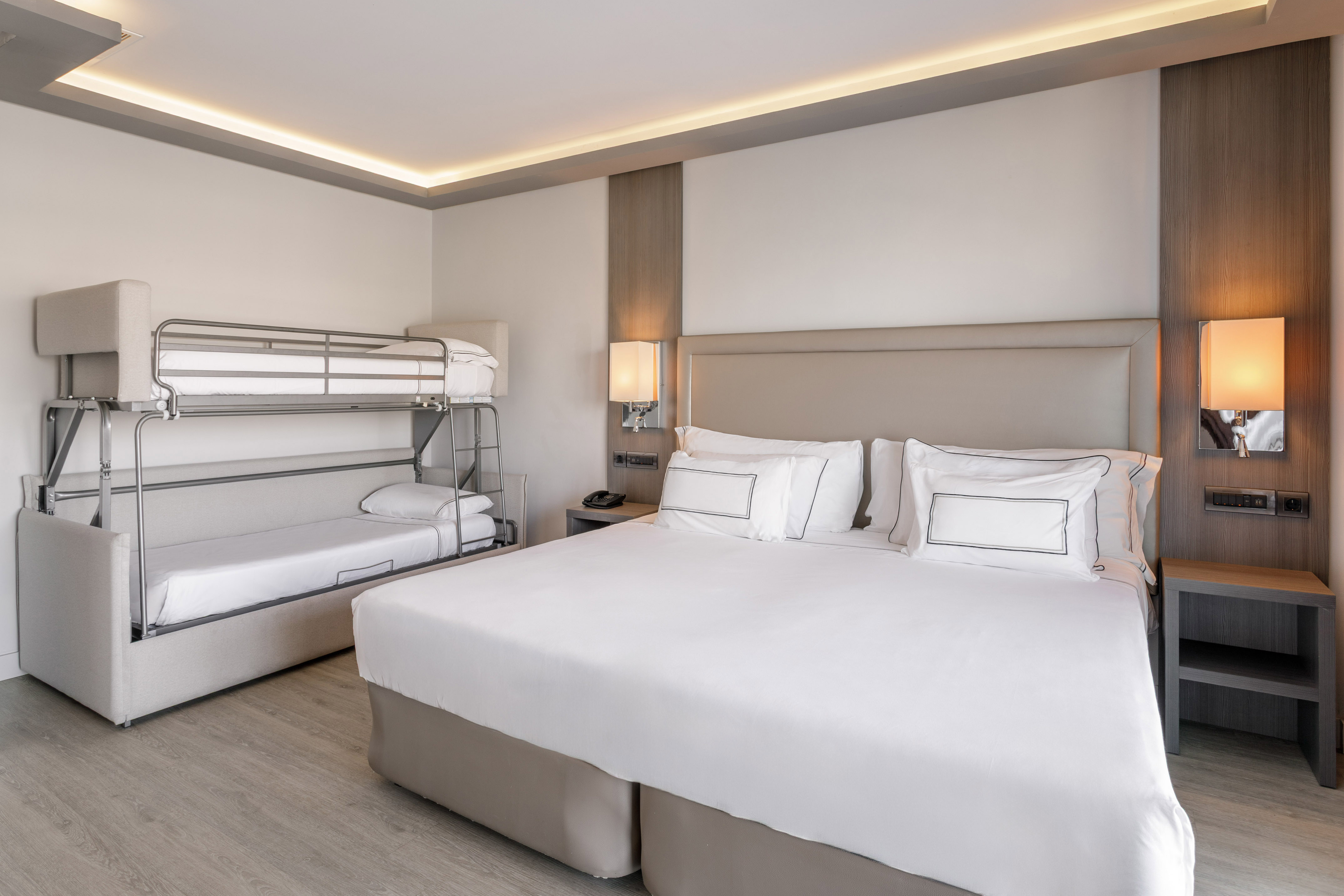 Habitación familiar de hotel moderna con cama doble, litera y cama supletoria.