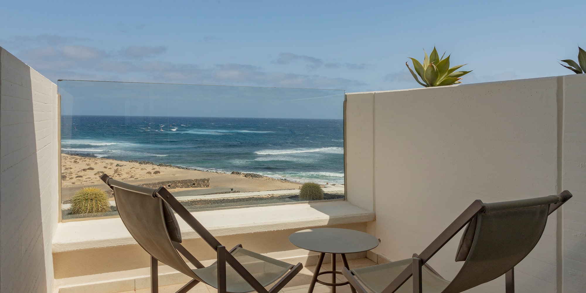 chairs on a balcony overlooking the ocean