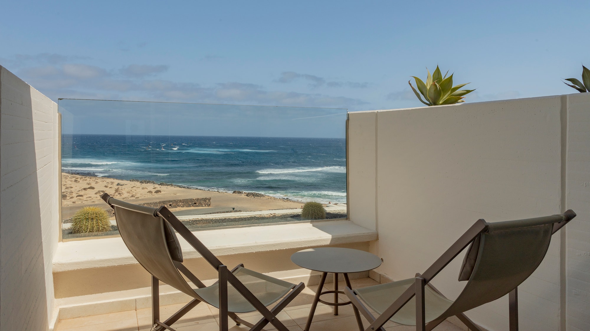 chairs on a balcony overlooking the ocean