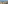 Balcony with ocean view, sandy beach, desert plants, chairs, and table.