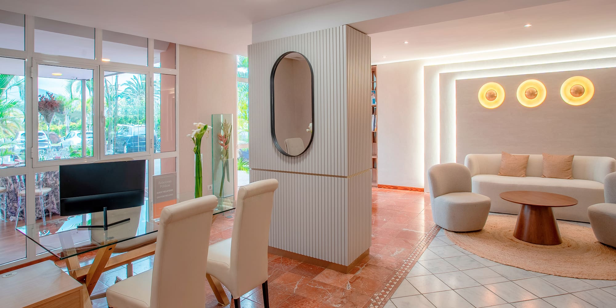 a room with a glass table and chairs
