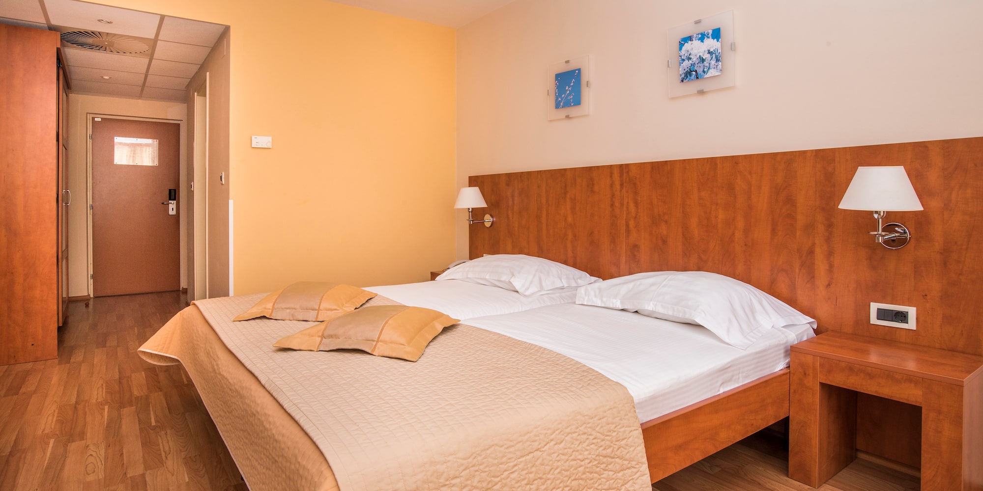 a bed with pillows and a lamp in a room