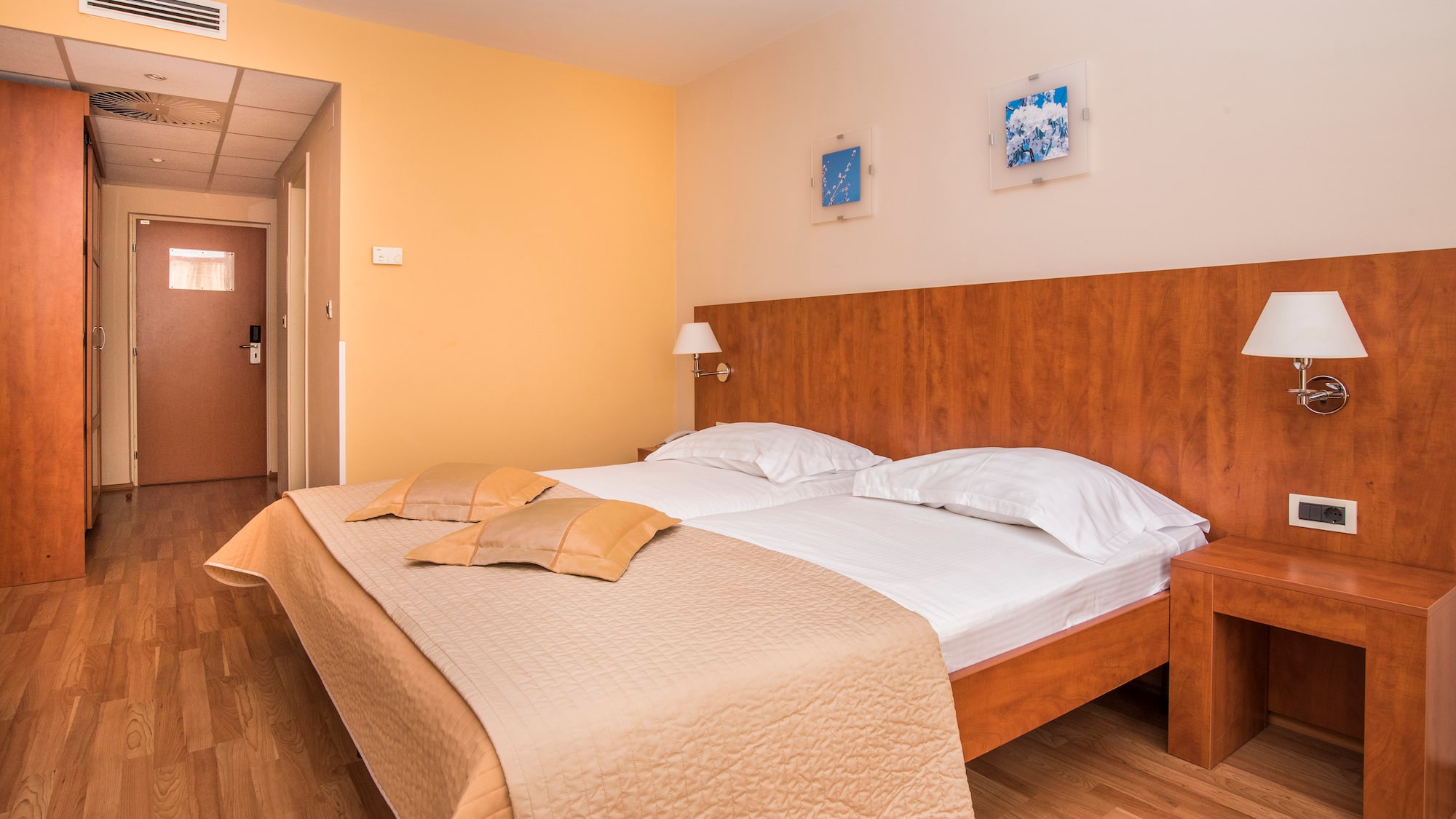 a bed with pillows and a lamp in a room