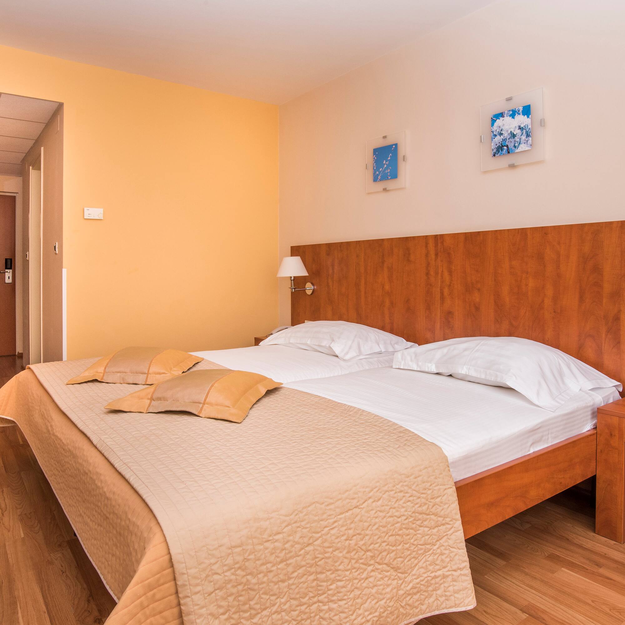 a bed with pillows and a lamp in a room