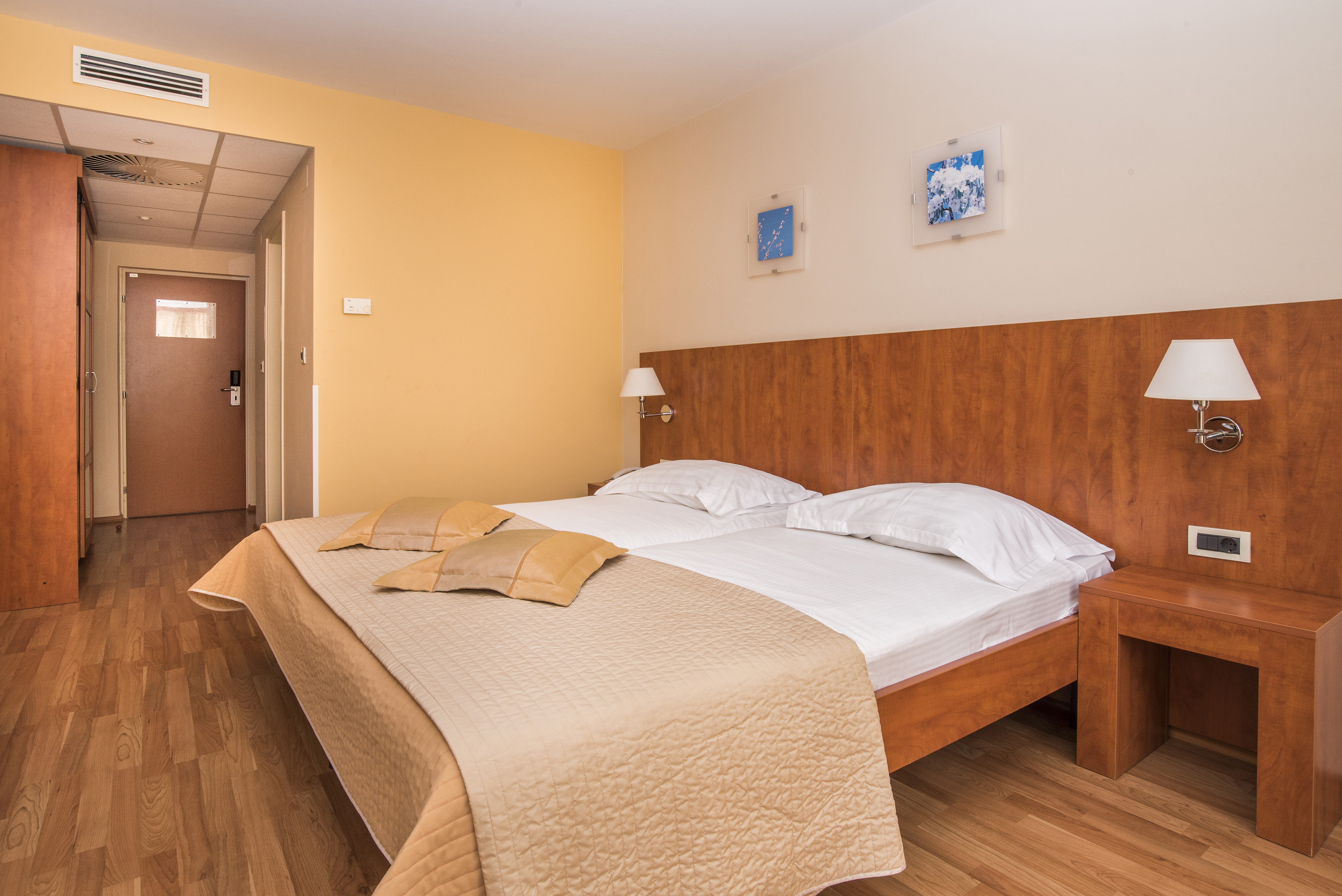 a bed with pillows and a lamp in a room