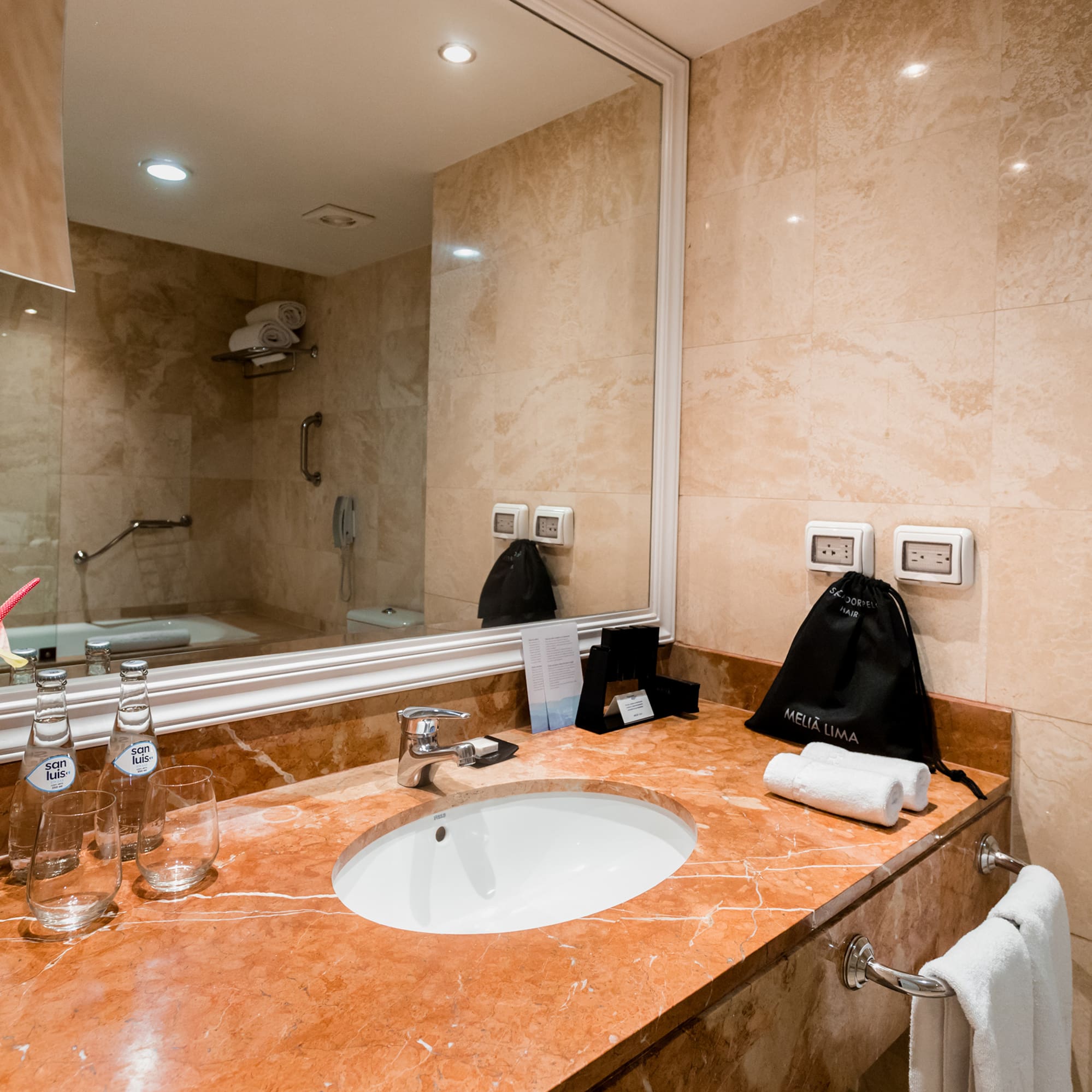 a bathroom with a marble countertop and a mirror