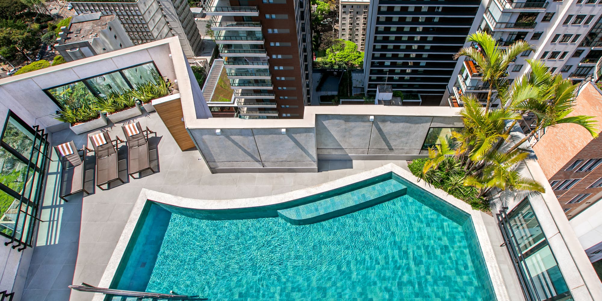 a pool with a ladder and a city view