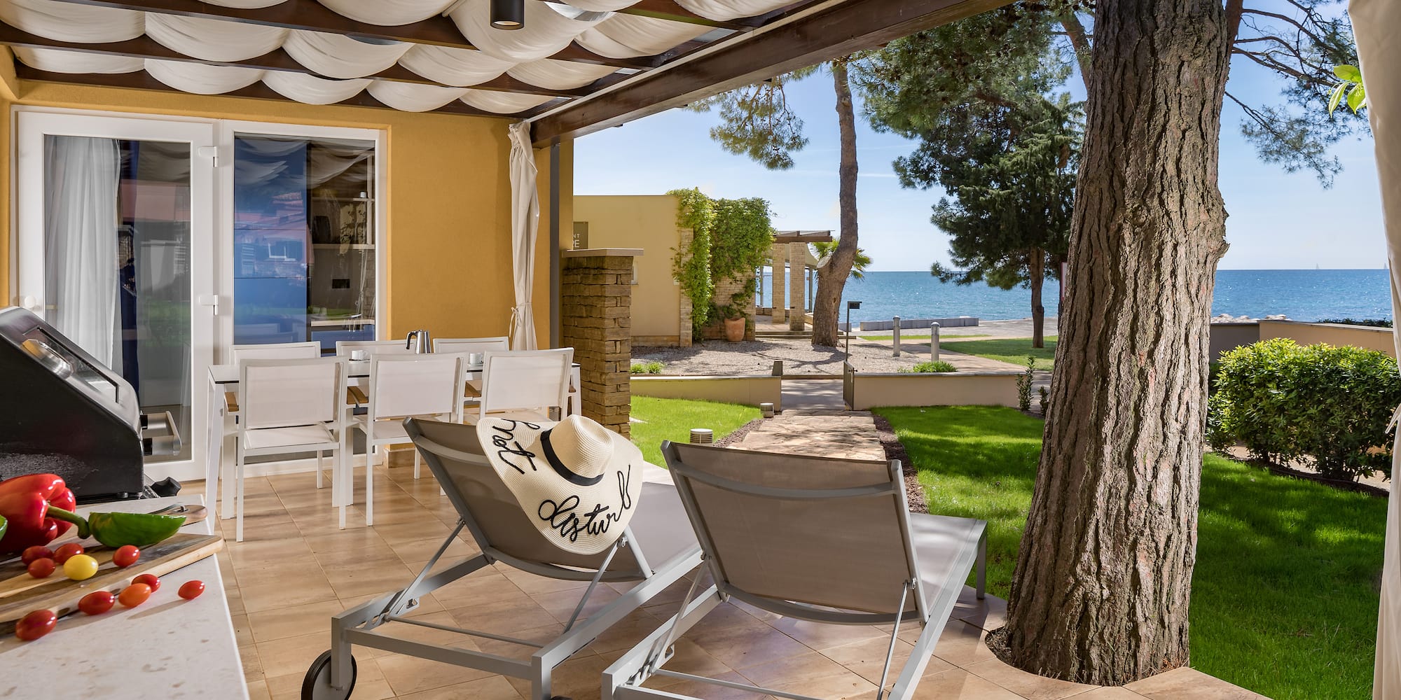 a deck with chairs and a tree and a large tree