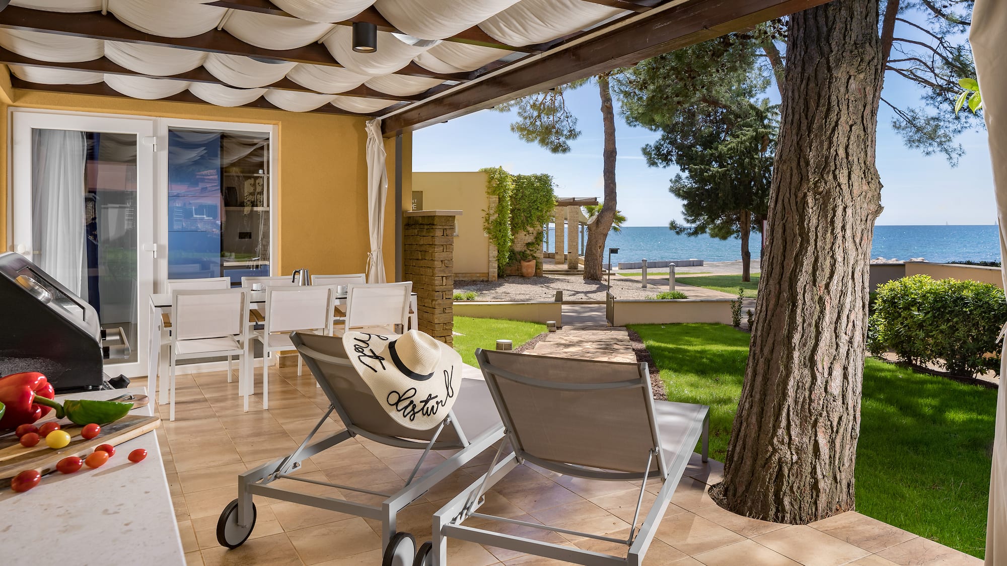 a deck with chairs and a tree and a large tree