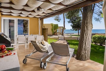 a deck with chairs and a tree and a large tree