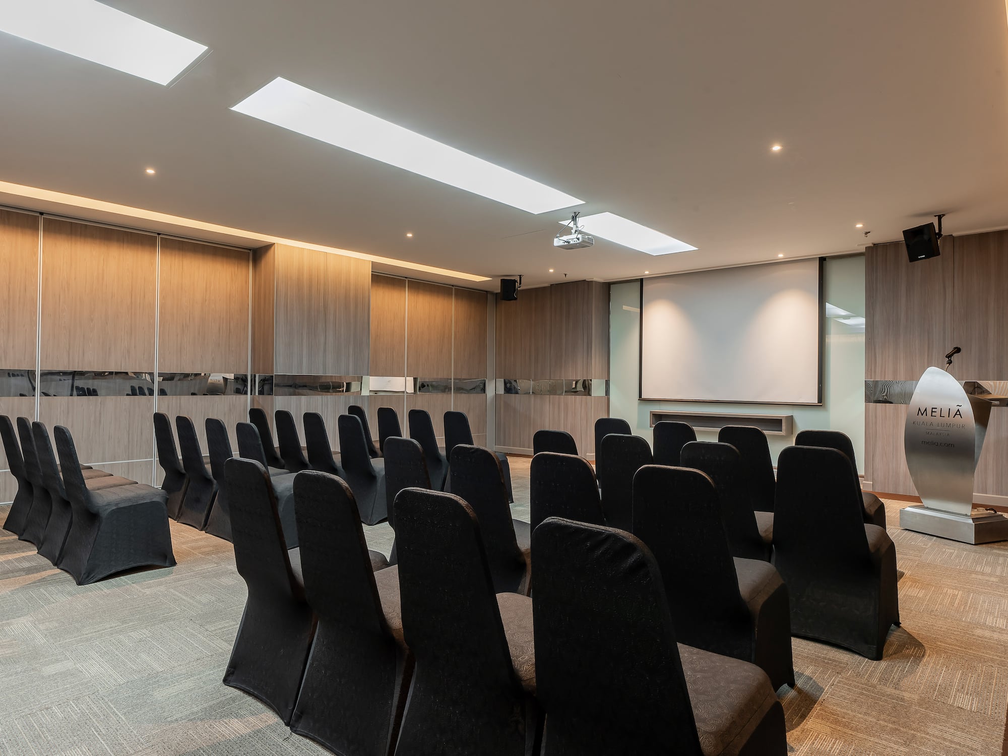 a room with chairs and a projector screen