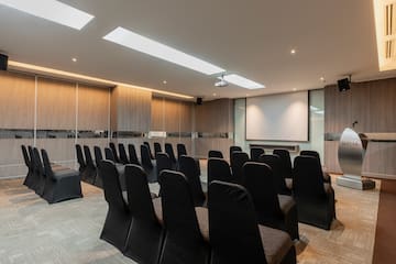 a room with chairs and a projector screen