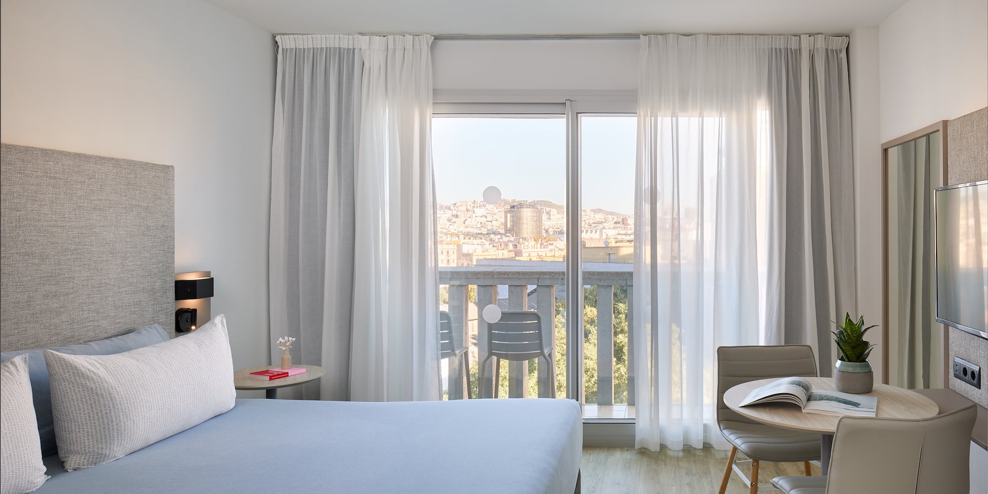 a bedroom with a bed and a table and chairs