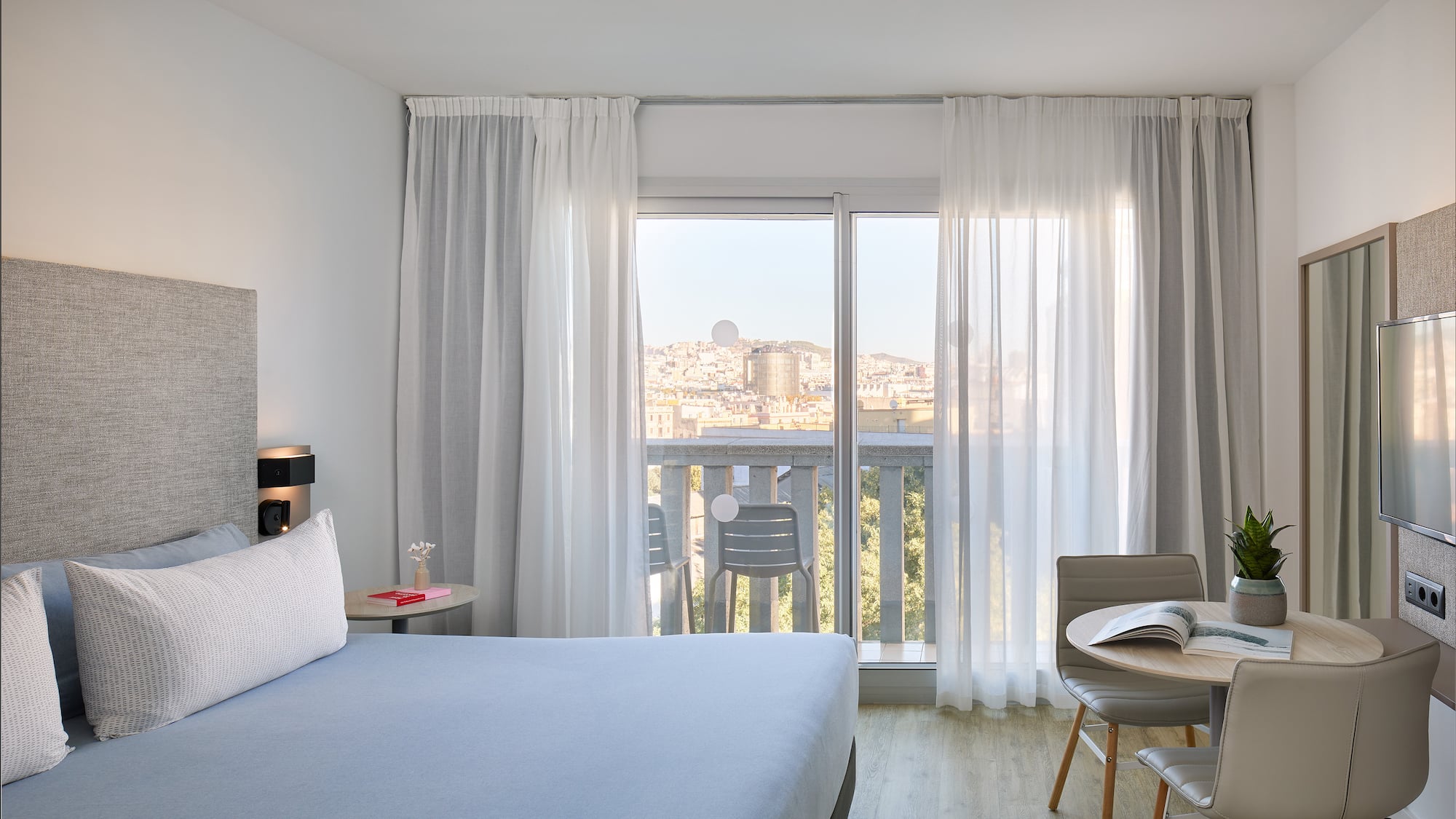 a bedroom with a bed and a table and chairs