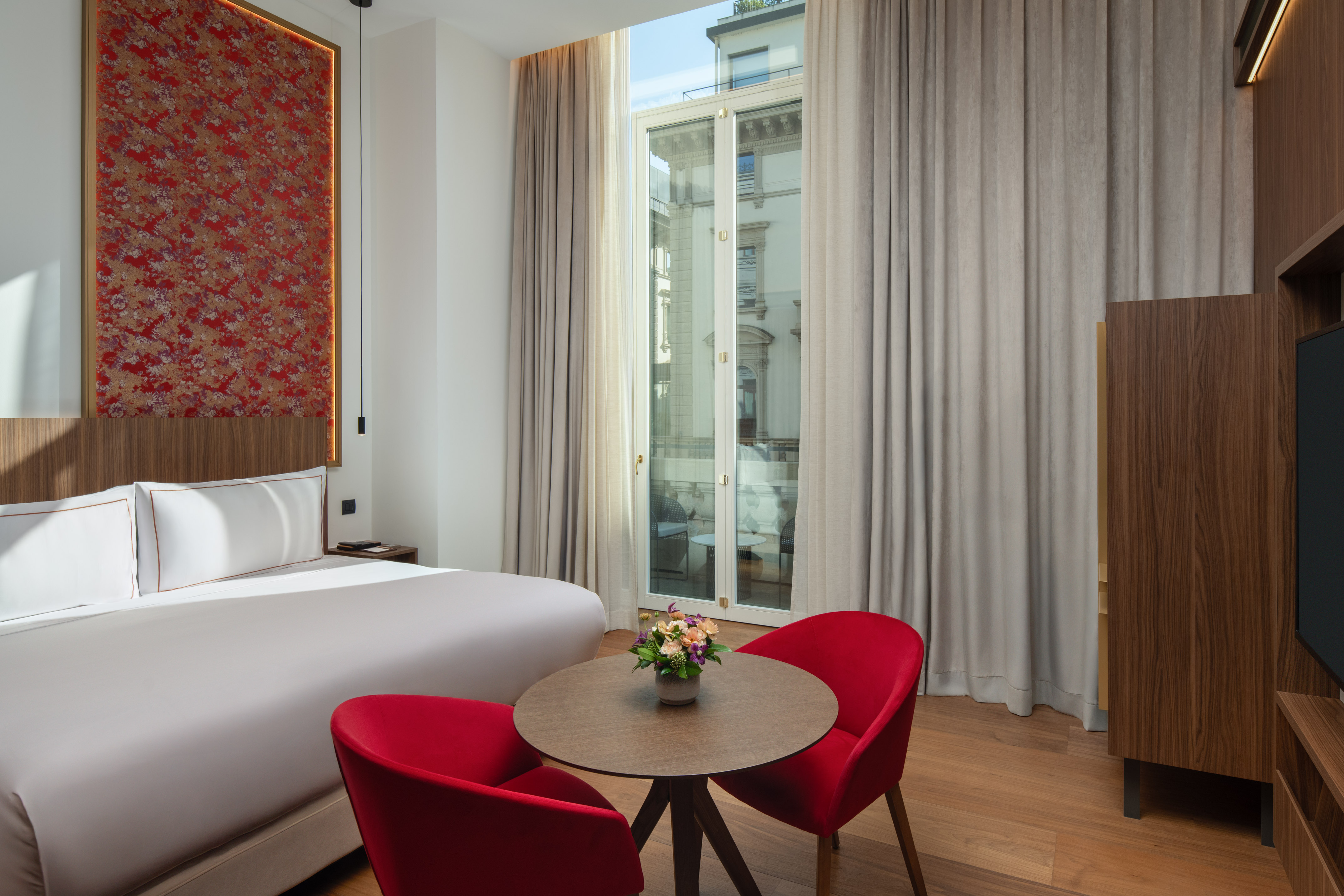 a room with a bed and a table with chairs