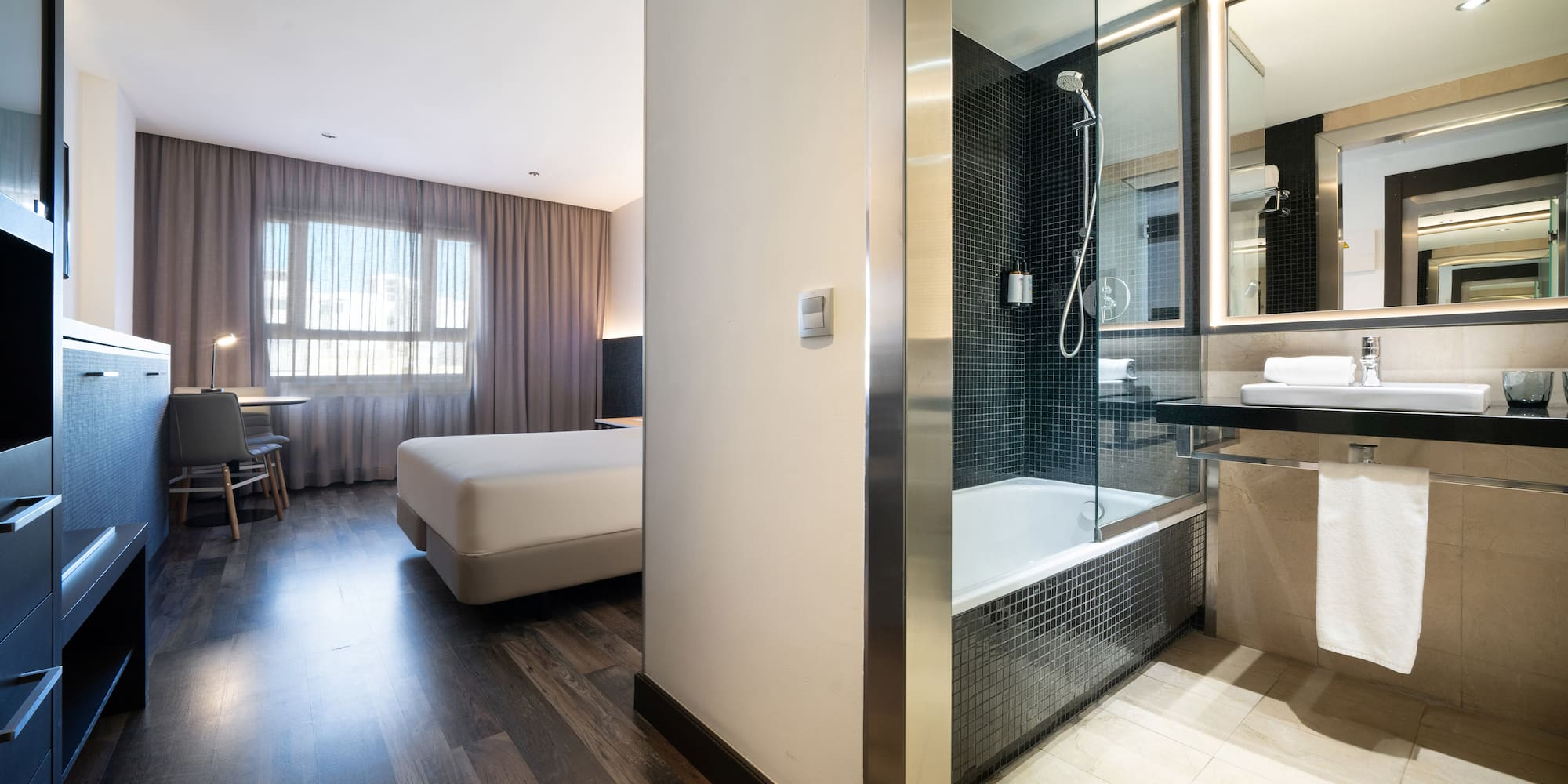 a bathroom with a bed and a shower