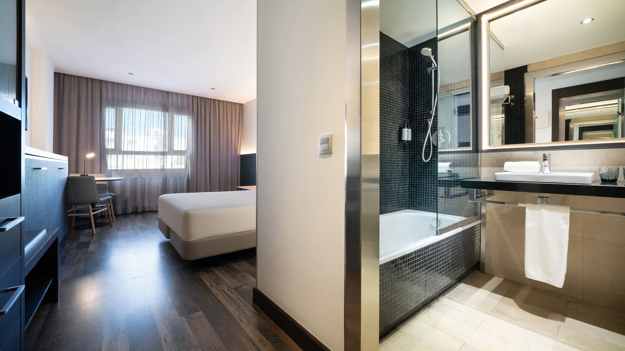 a bathroom with a bed and a shower