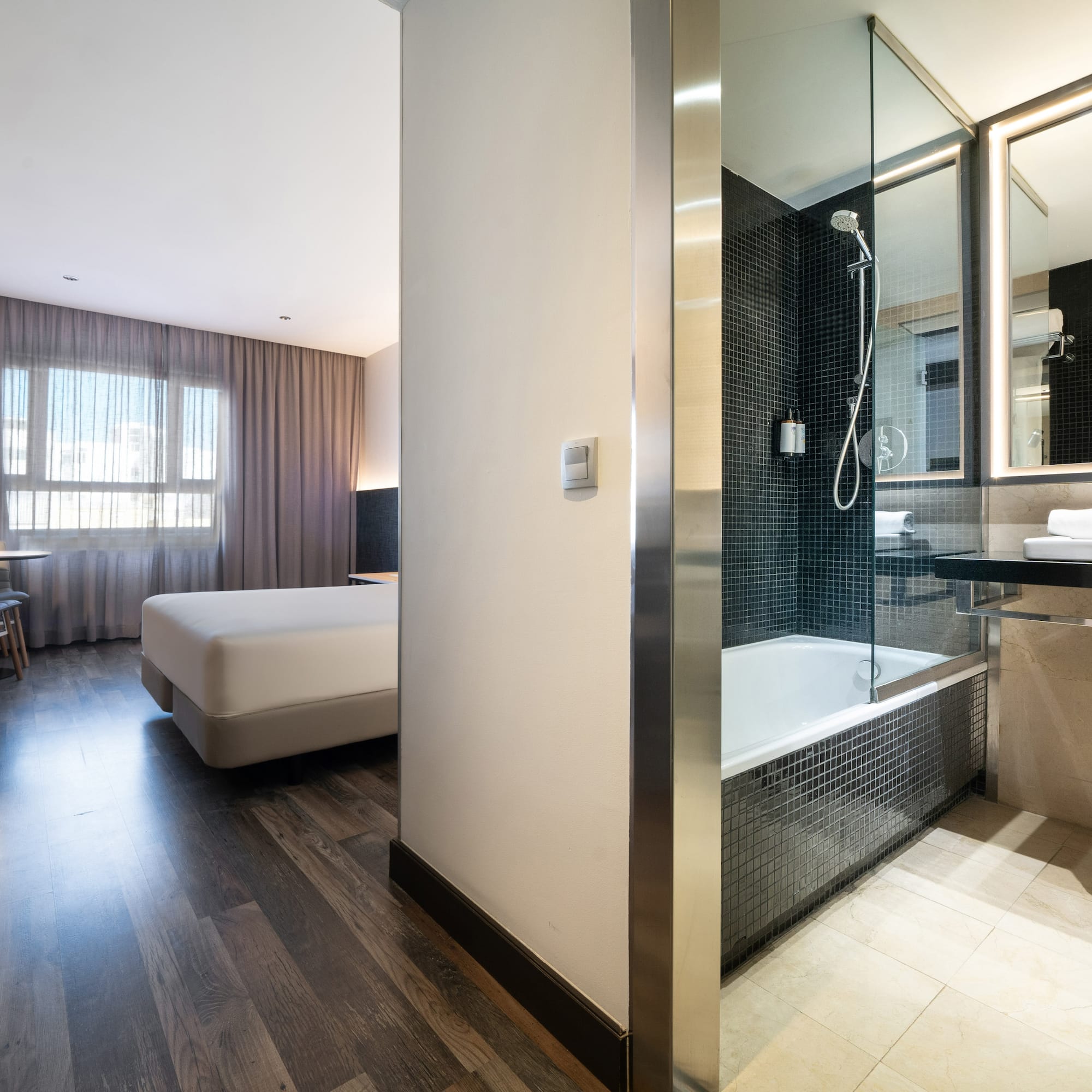 a bathroom with a bed and a shower