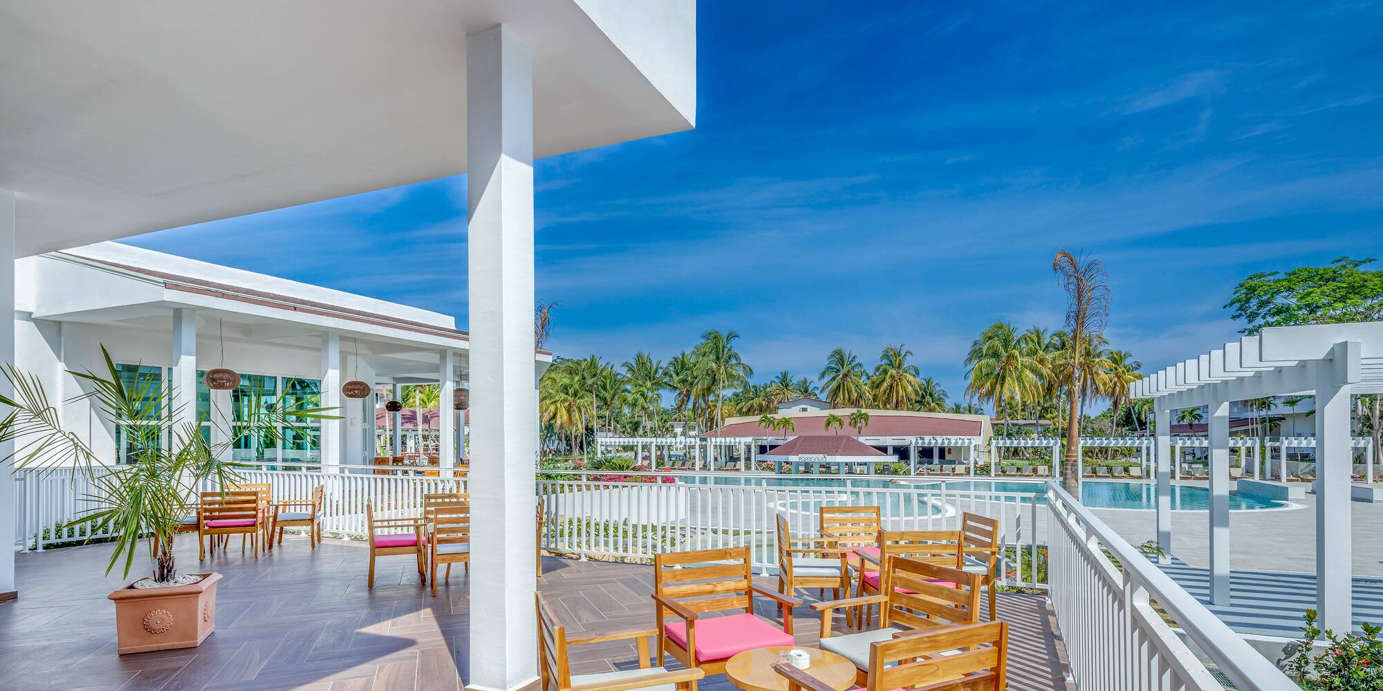 a patio with chairs and tables on a deck