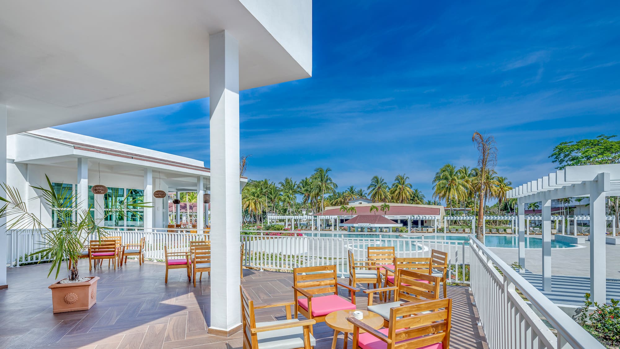 a patio with chairs and tables on a deck