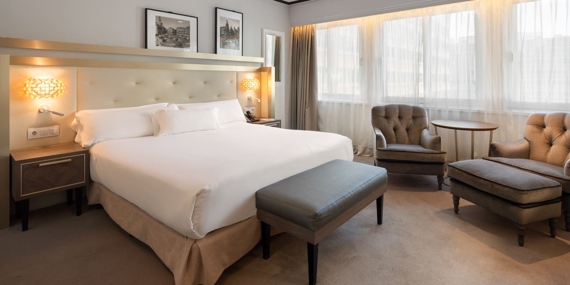 a bedroom with a bed and chairs