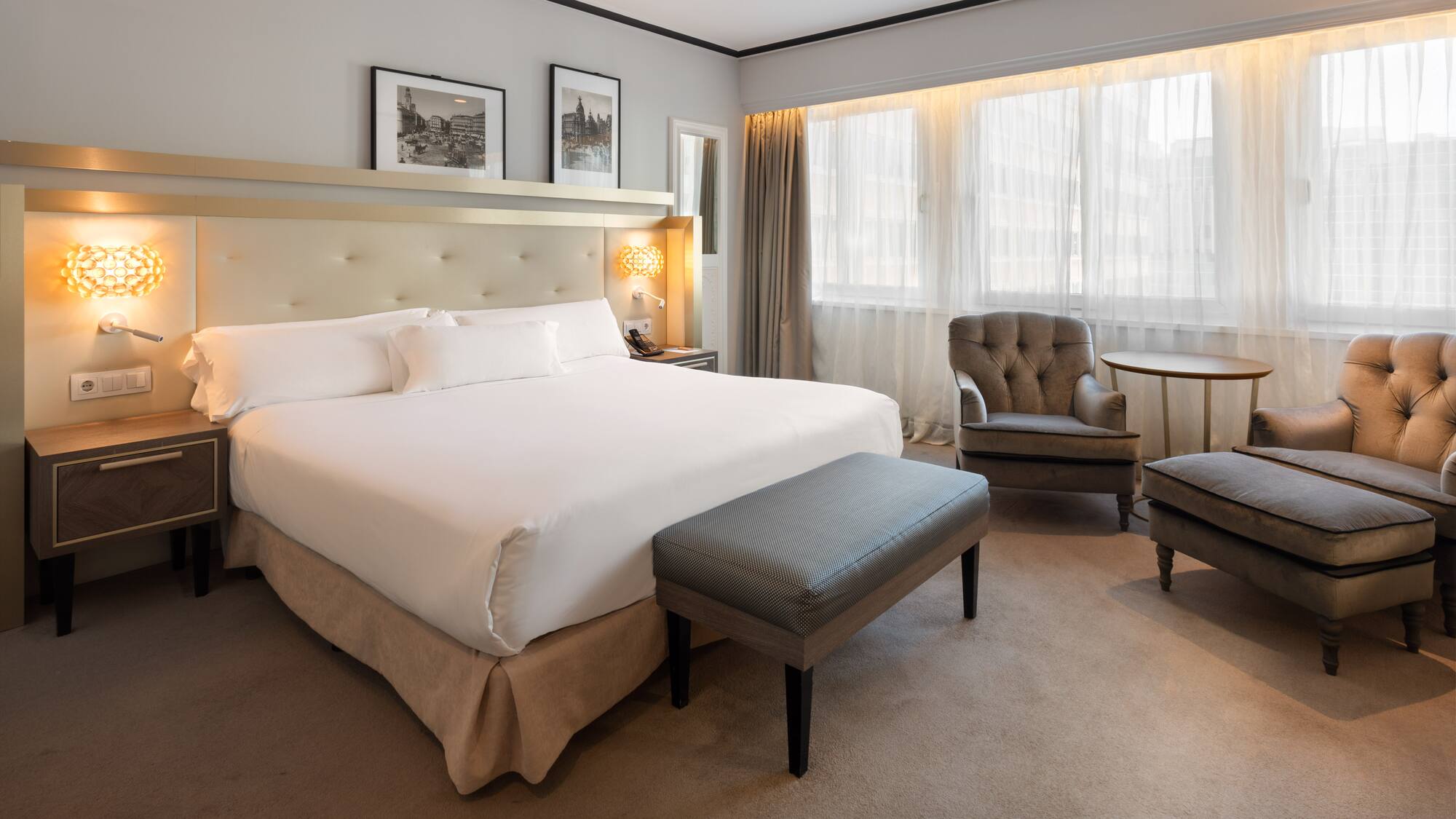 a bedroom with a bed and chairs