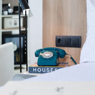 a telephone on a book on a nightstand