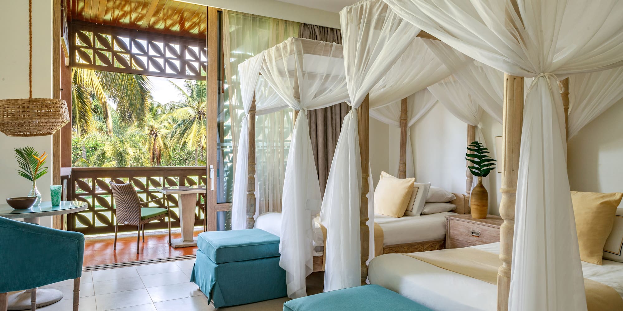 a room with four beds and a balcony