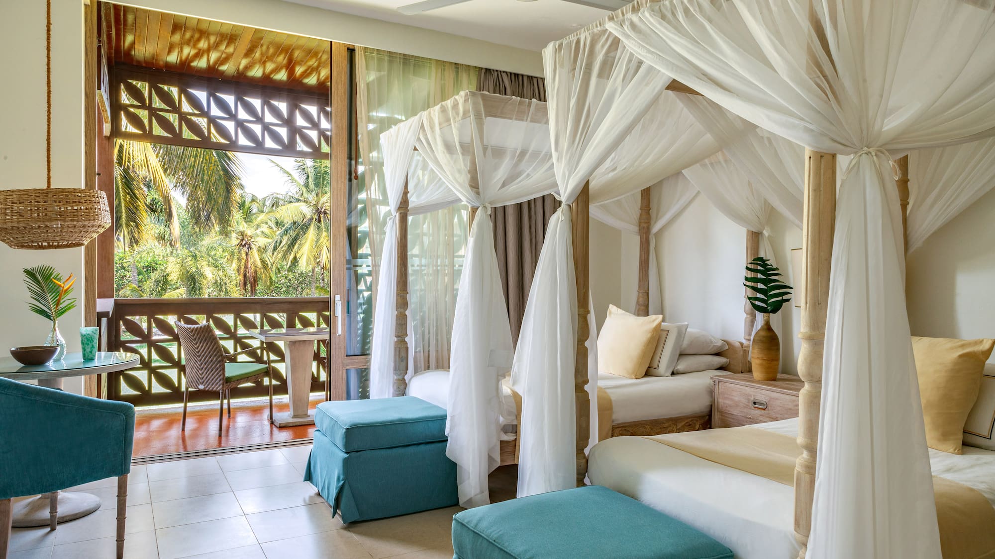 a room with four beds and a balcony