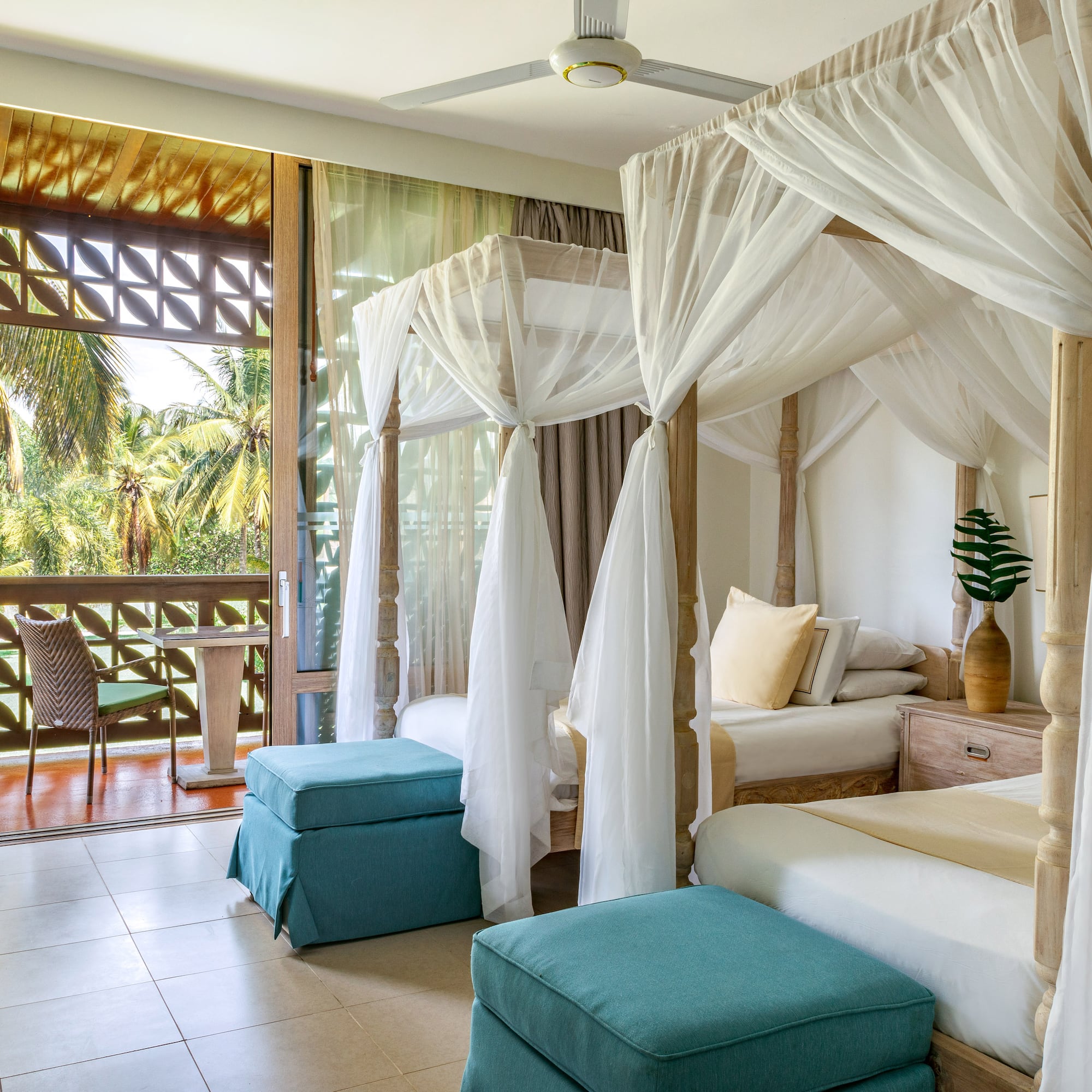 a room with four beds and a balcony