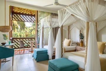 a room with four beds and a balcony