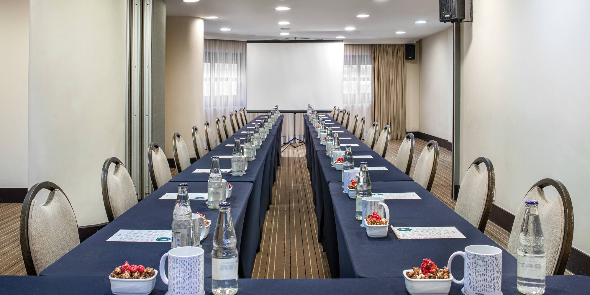 a long conference room with tables and chairs