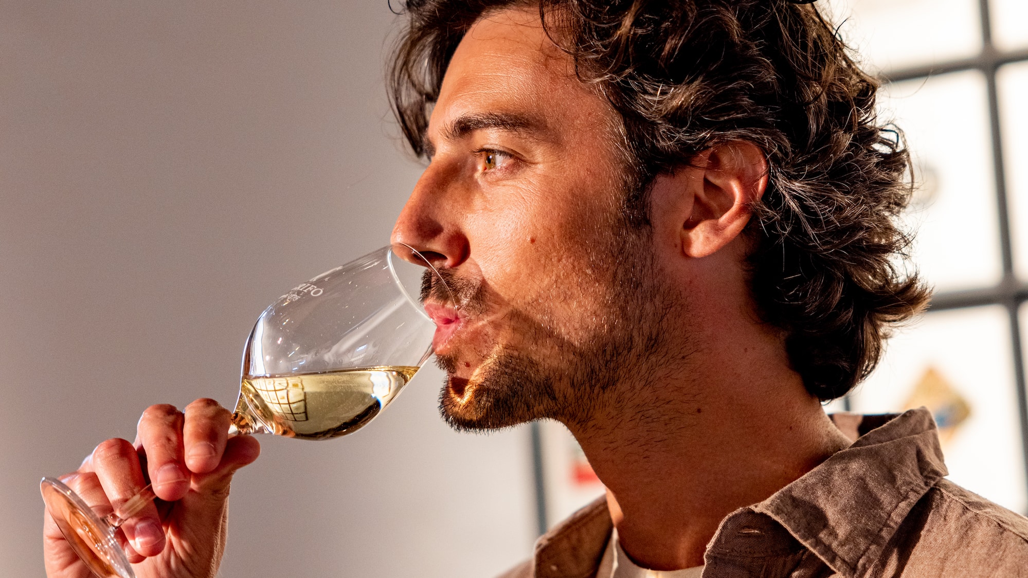 a man drinking from a wine glass
